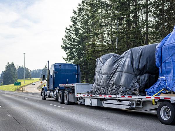 flatbed semi towing a load on highway