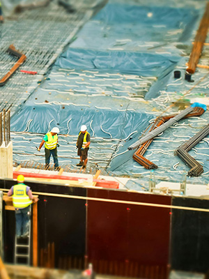 two men on construction site with building materials