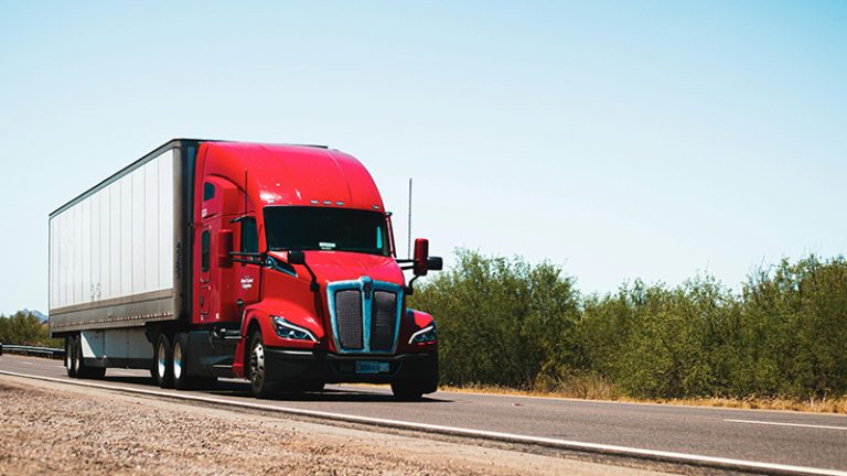 red semi truck hauling a full truckload